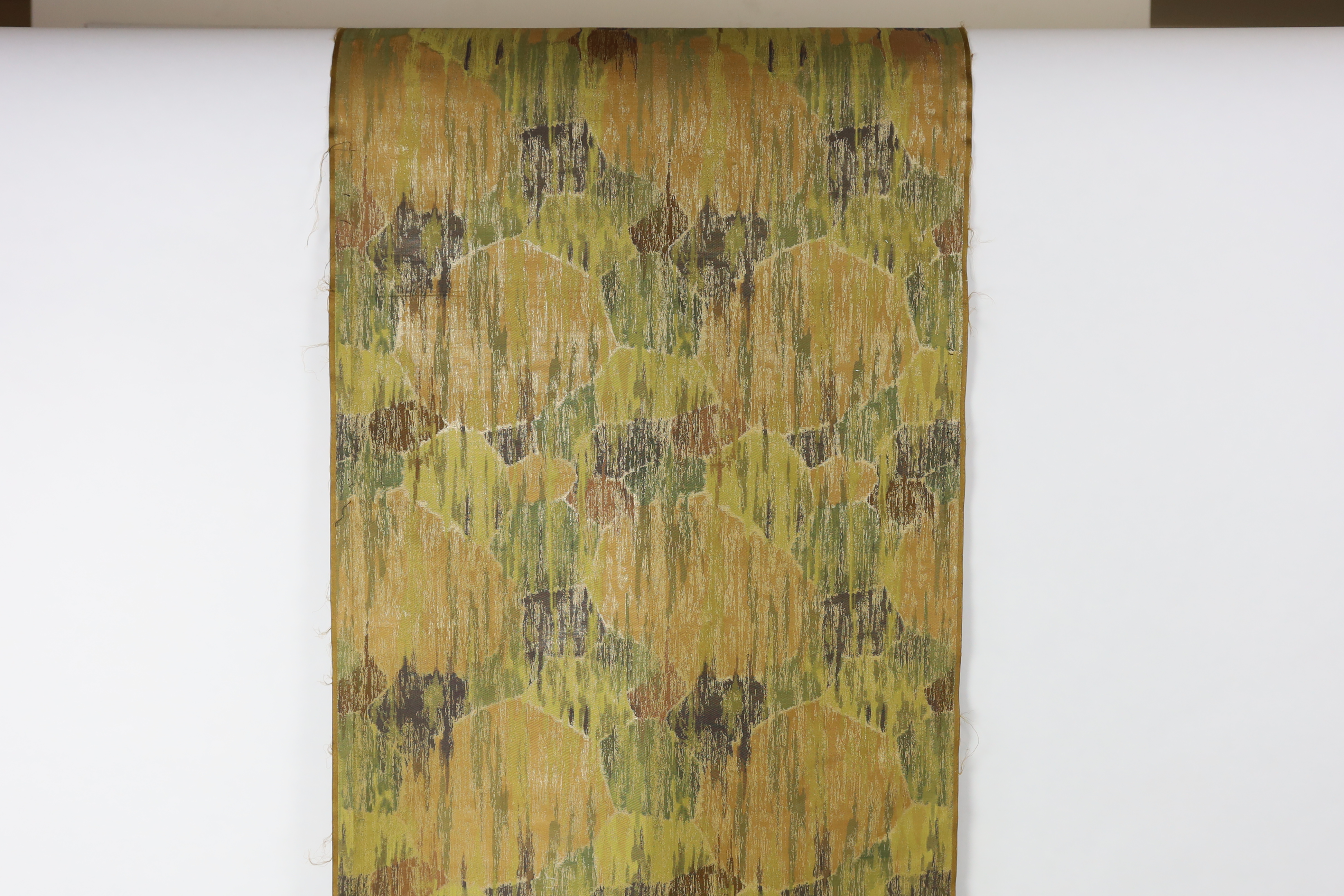 A 1930’s Japanese Kyoto, possibly Nishijin and a Tsumugi hand loomed brocade, woven in fine gold and multi coloured threads, in an abstracted mountainous landscape pattern, originally possibly woven for an Obi, 69cm wide